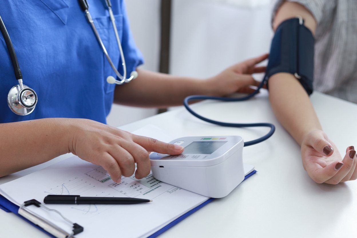 Doctor checking old woman patient arterial blood pressure. Healt